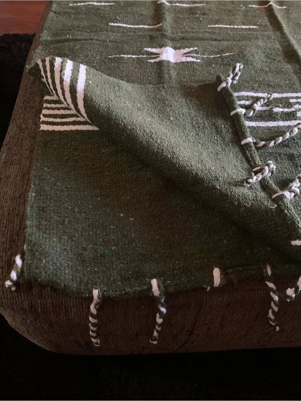 olive green Mexican-style blanket poncho featuring a geometric pattern
